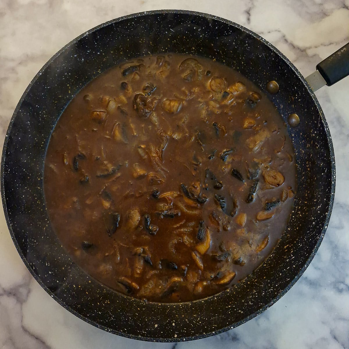 Step 10, boiling water added to the mushrooms, onions and stock cubes.