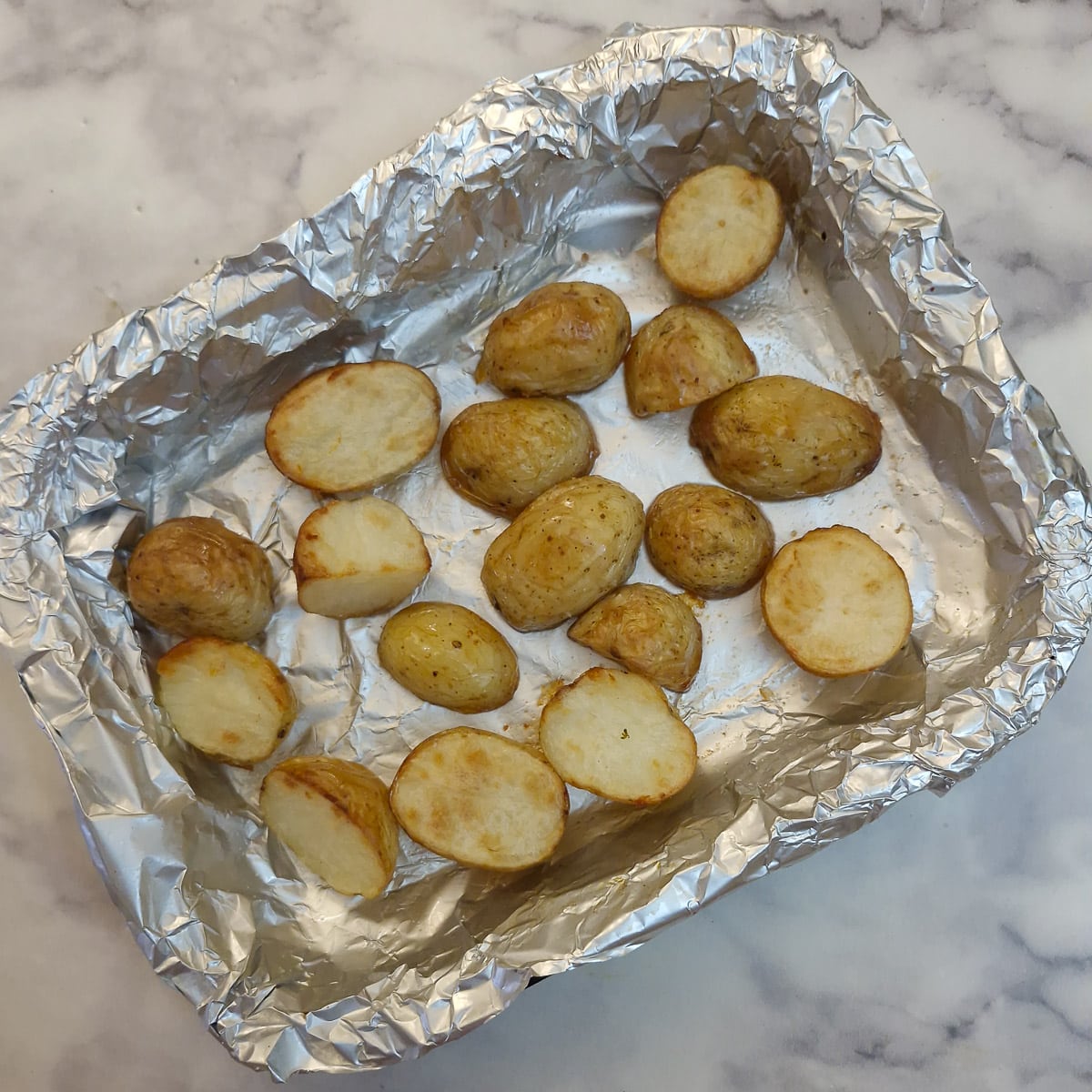 Step 2, browned roasted potatoes in a baking dish.