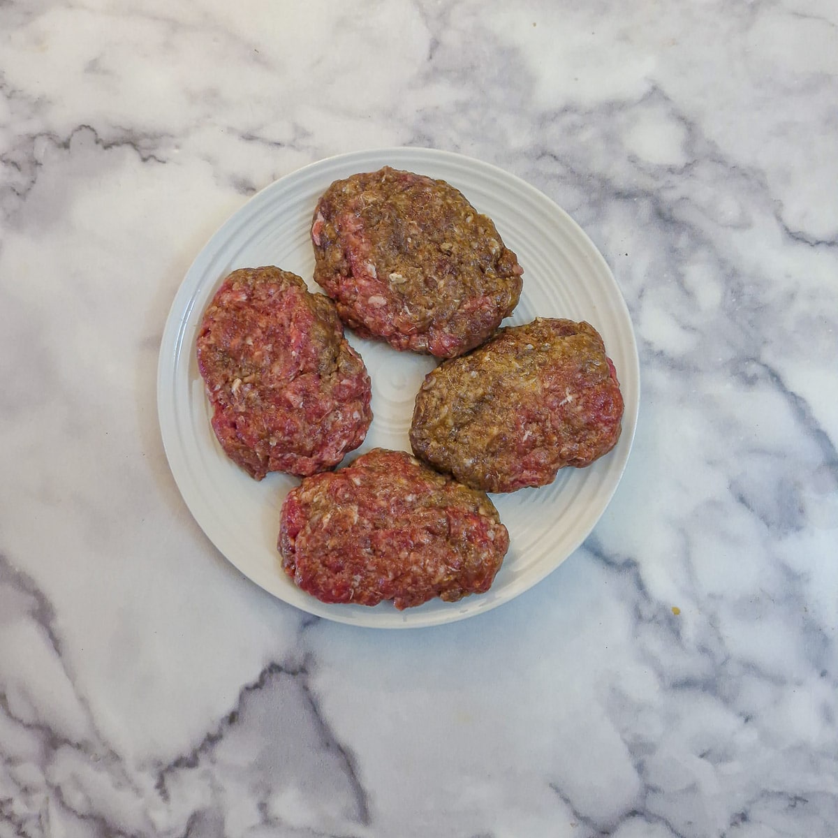 Step 5, 4 minced beef patties on a plate.