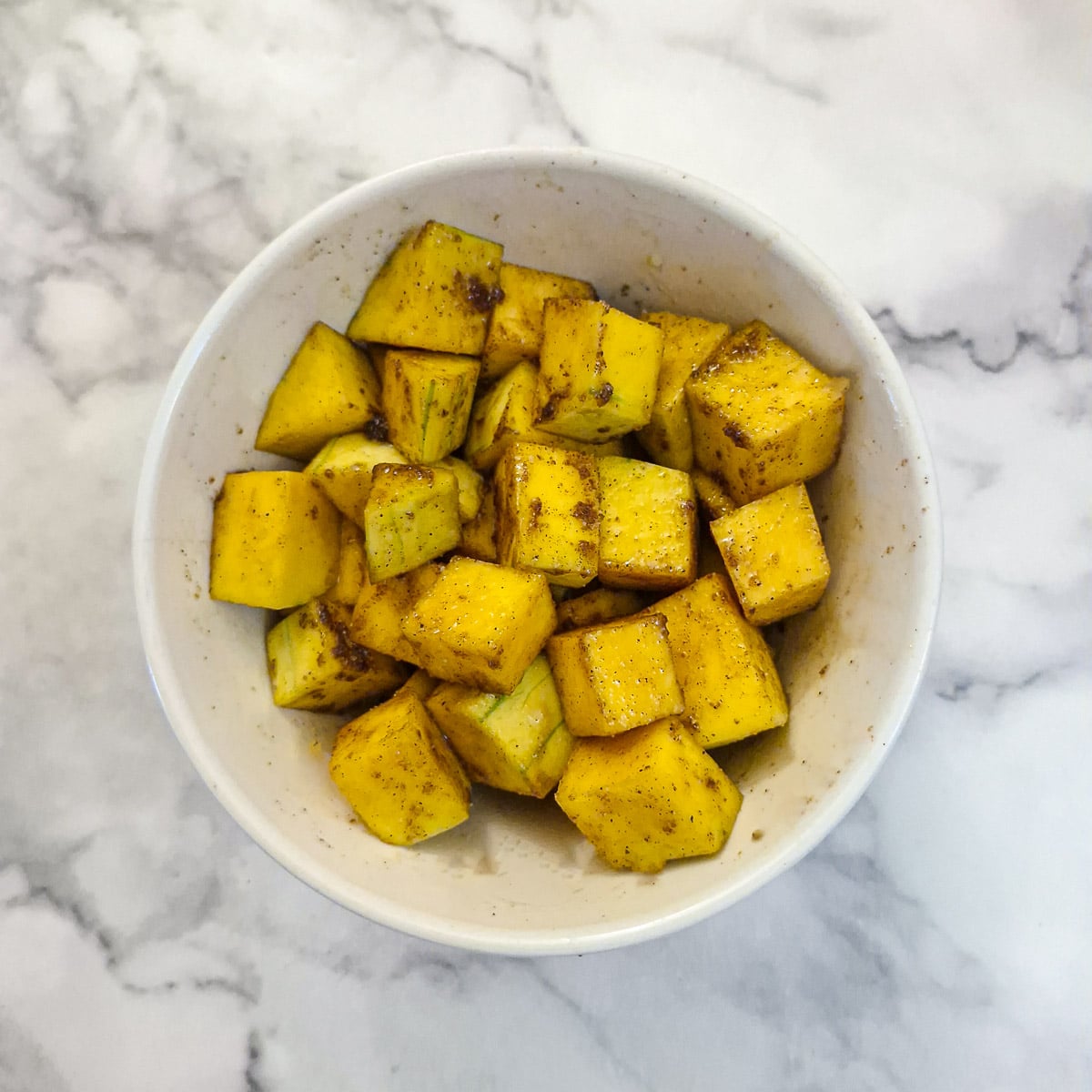 Cubed butternut coated with cinnamon, brown sugar and vegetable oil.