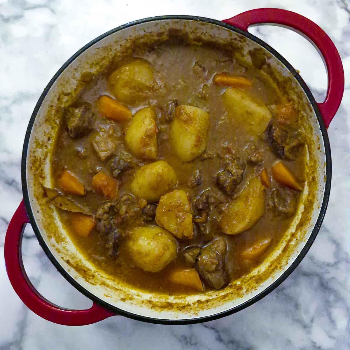 Step 8, a casserole dish of fully cooked tamatie bredie, with a thick gravy.