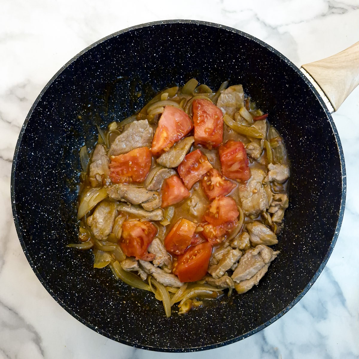 Fresh tomatoes added to the wok.