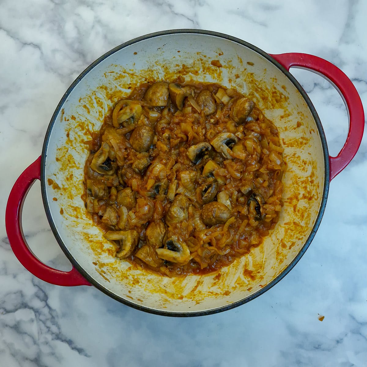 Mushsrooms and tomato paste stirred into the onions.