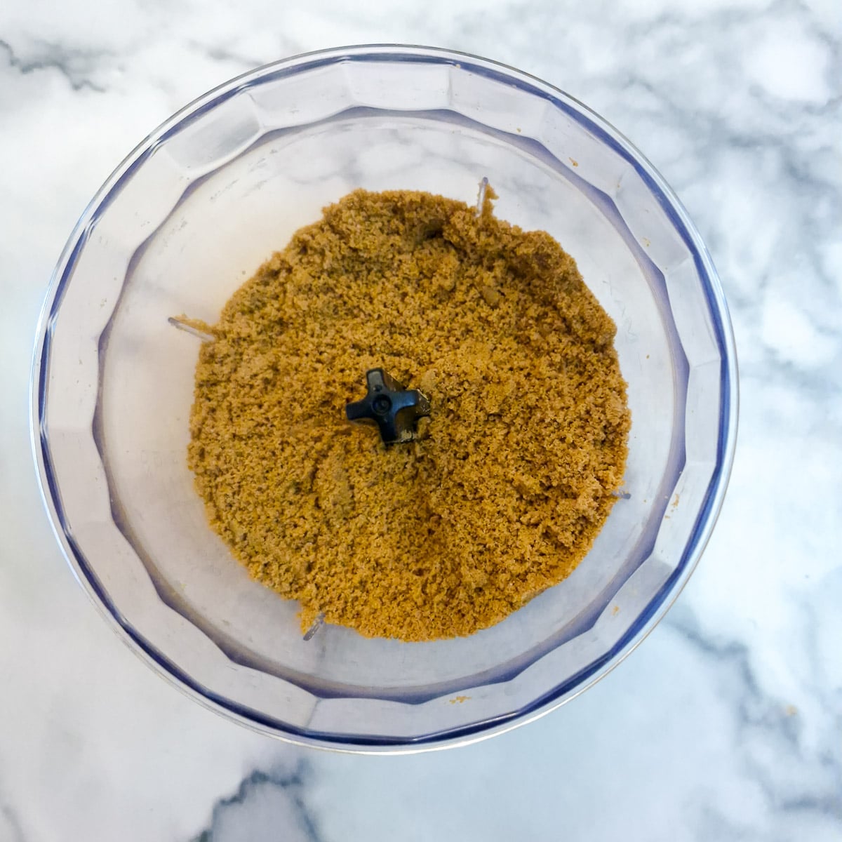 Step 1, ginger biscuits made into fine crumbs in a food processor.