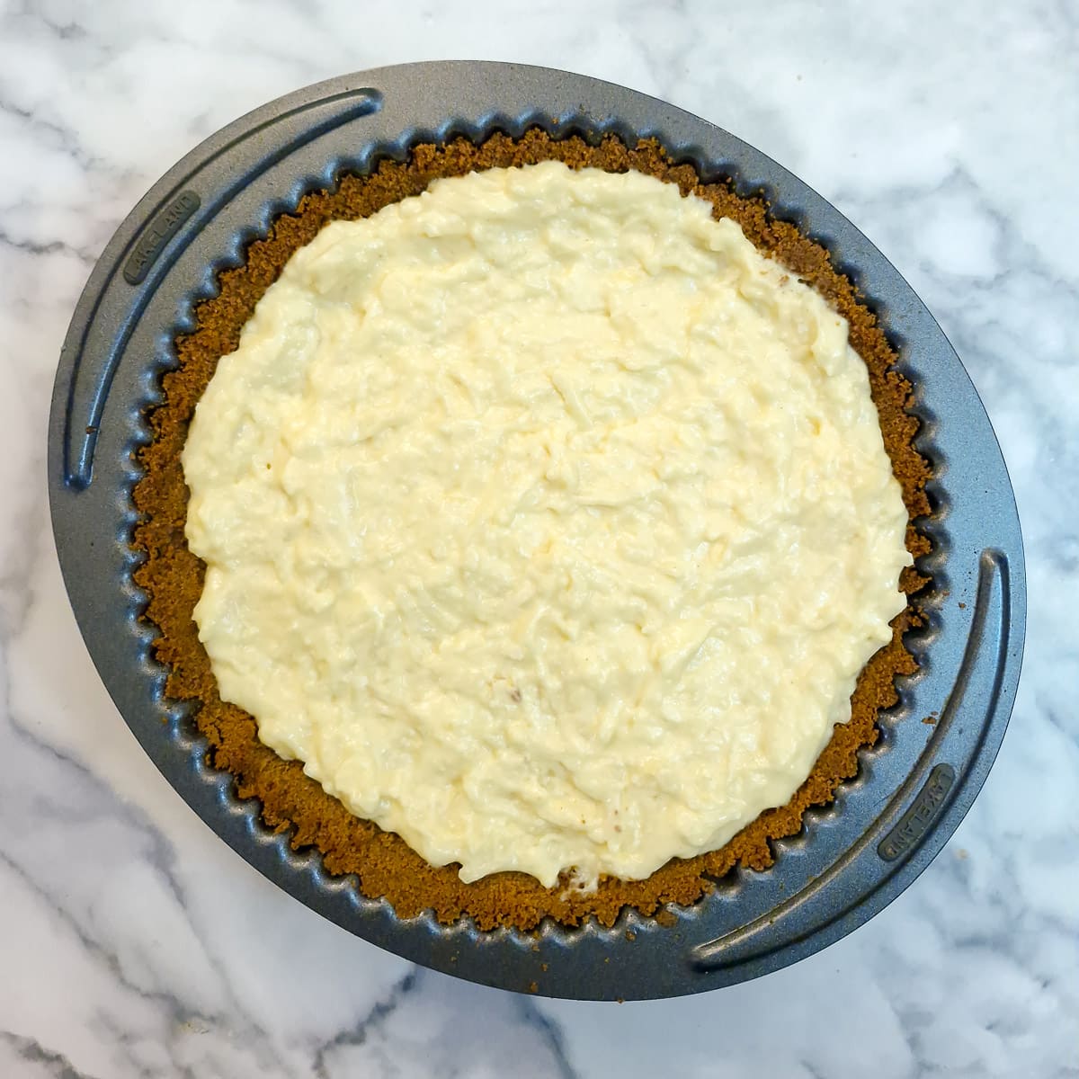 Step 9, the custard filling pourred into the biscuit crust.