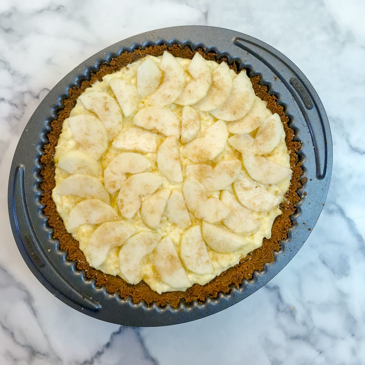 Step 10, sliced pears arranged on top of the custard.