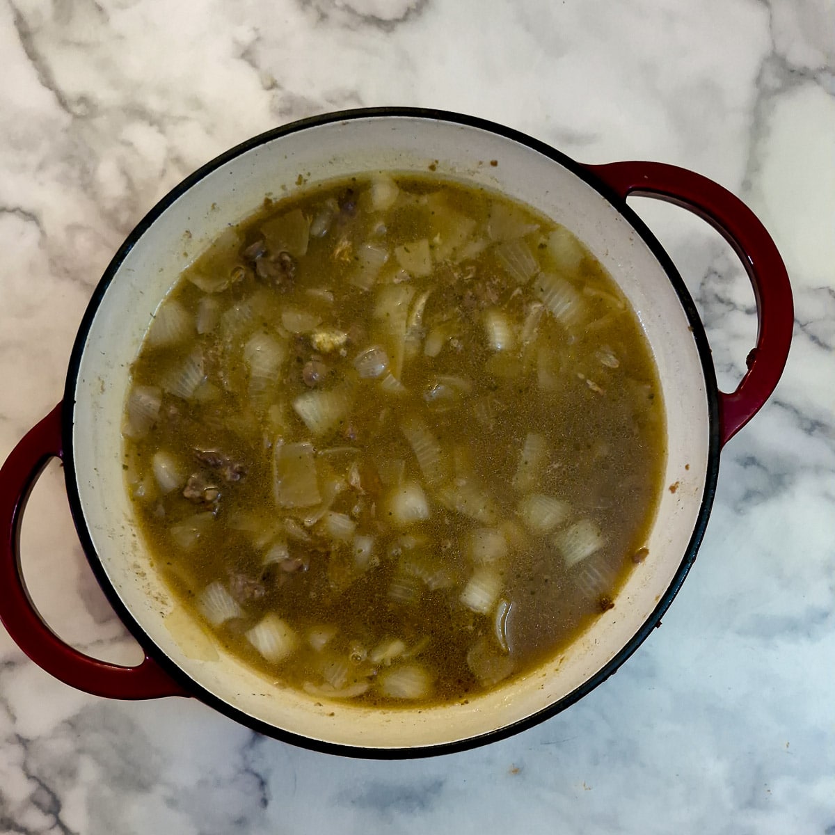 Step 4, stock added to the pan with the meat and onions.
