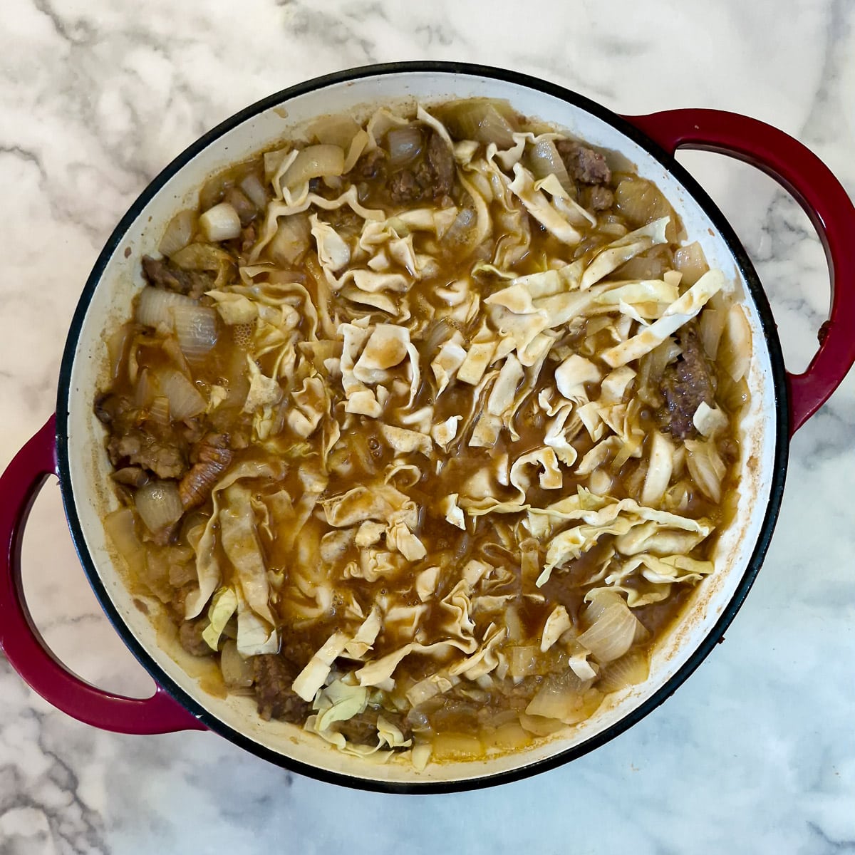 Step 5, shredded cabbage added to the pan.