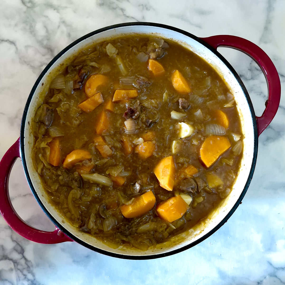 Step 7, chunky pieces of carrots added to the hotpot.