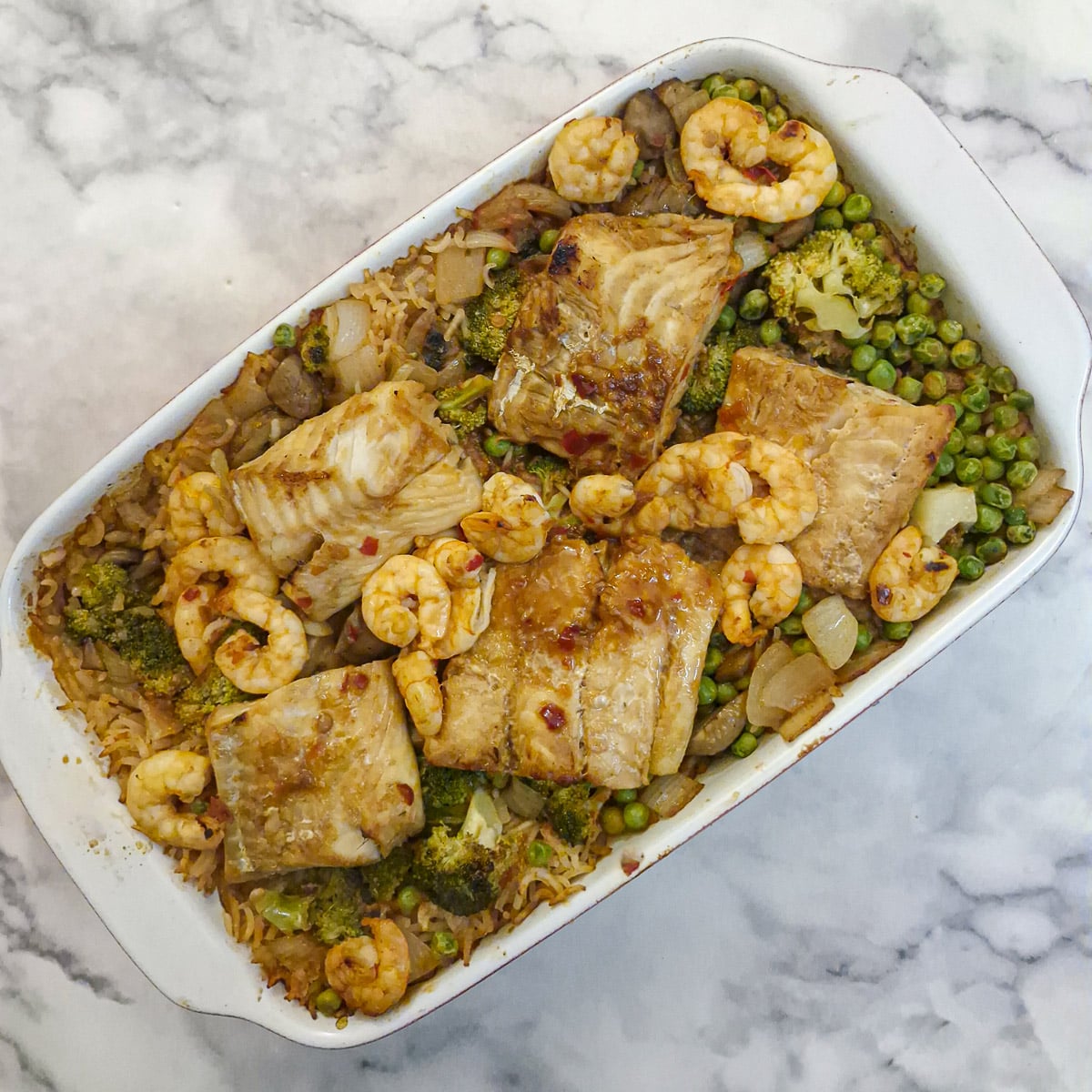 A dish of fully cooked swet chilli vegetable rice bake,. It shows how the rice has absorbed all the liquid.