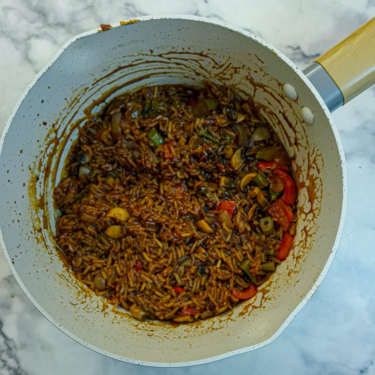 A pan of almost cooked sweet chilli vegetable rice.