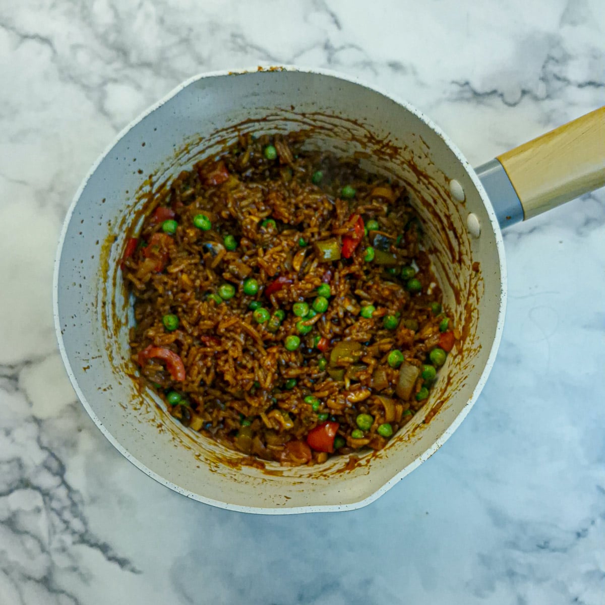 Peas stirred into the rice to finish off the dish.