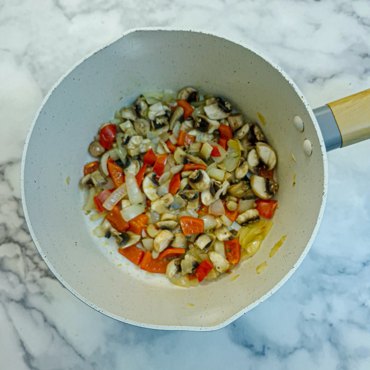 Chopped mushrooms added to the bell peppers and onions.