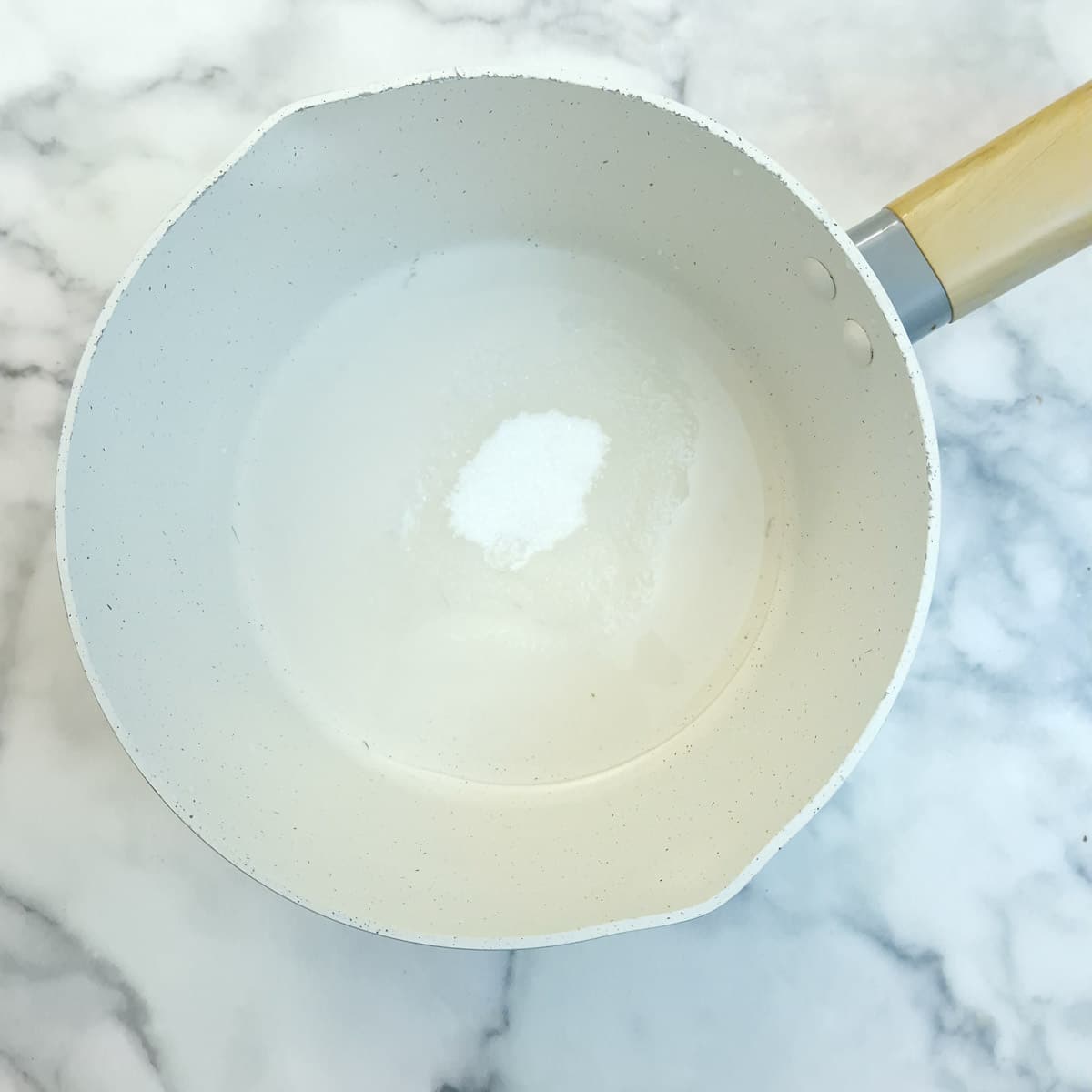 Sugar and water combined in a saucepan to make the caramel sauce.