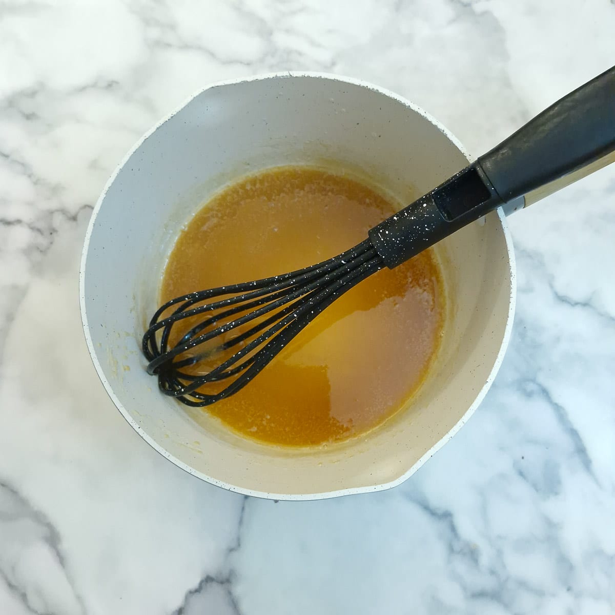 Butter whisked into the caramel sauce.