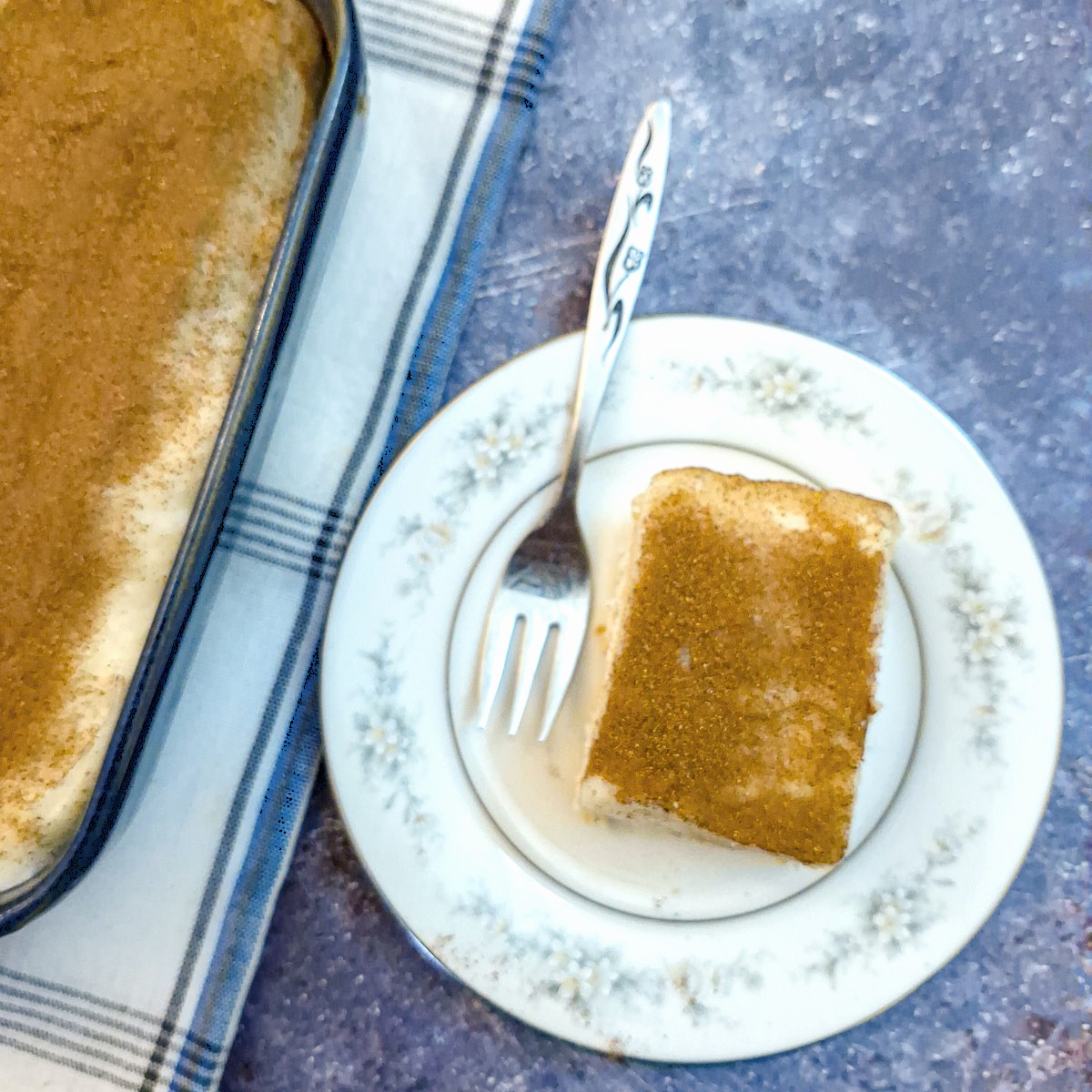 A slice of creamy no-bake layered custard dessert on a small while plate.