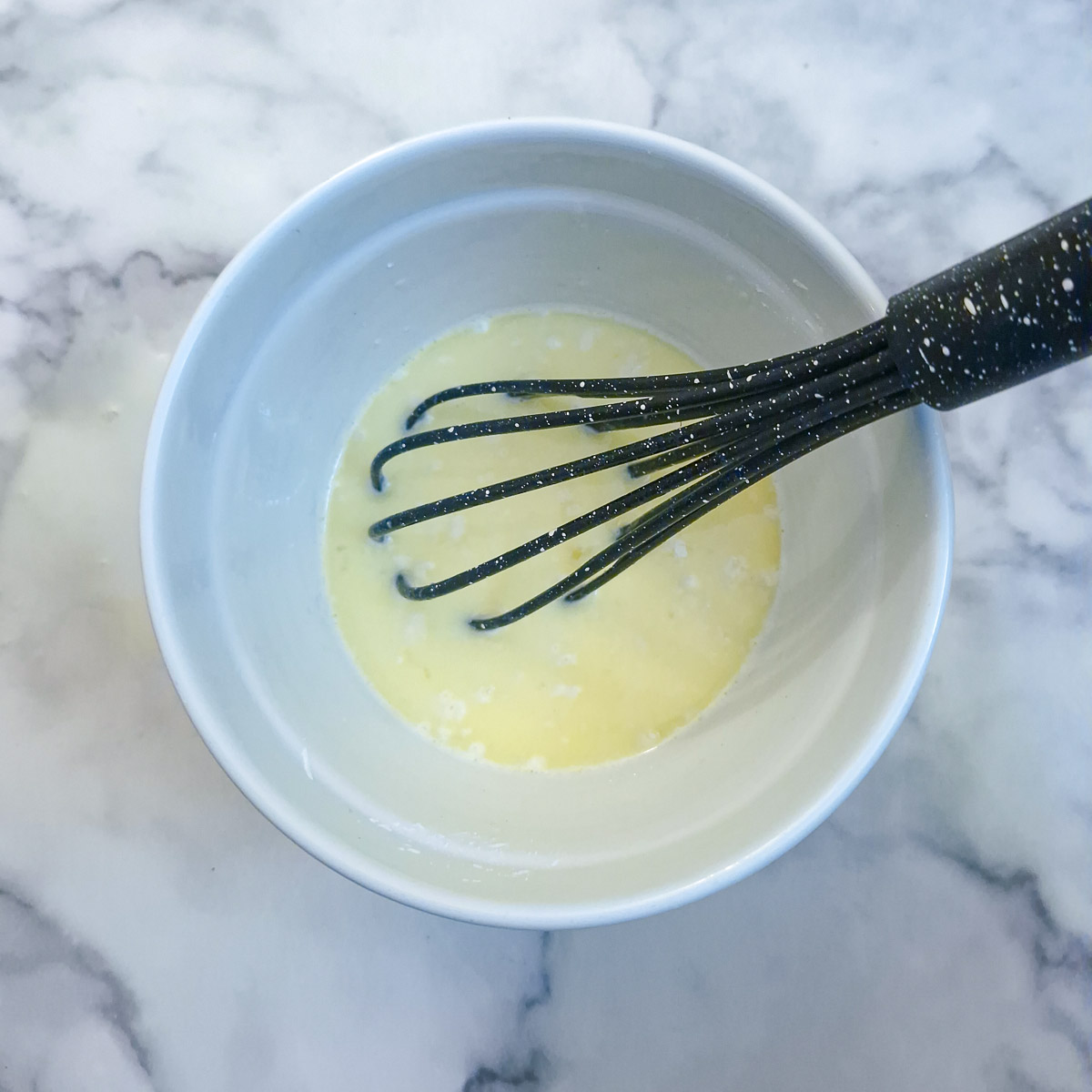 Hot milk added to the eggs and flour mixture.