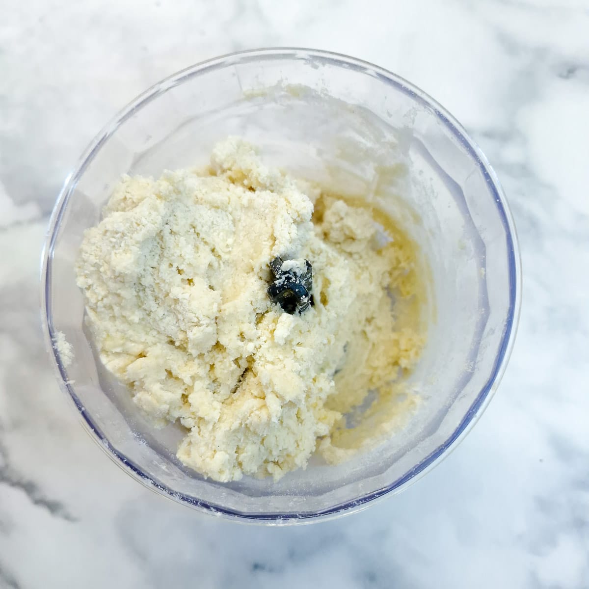The egg combined with the flour and butter to form a shaggy dough in a food processor.