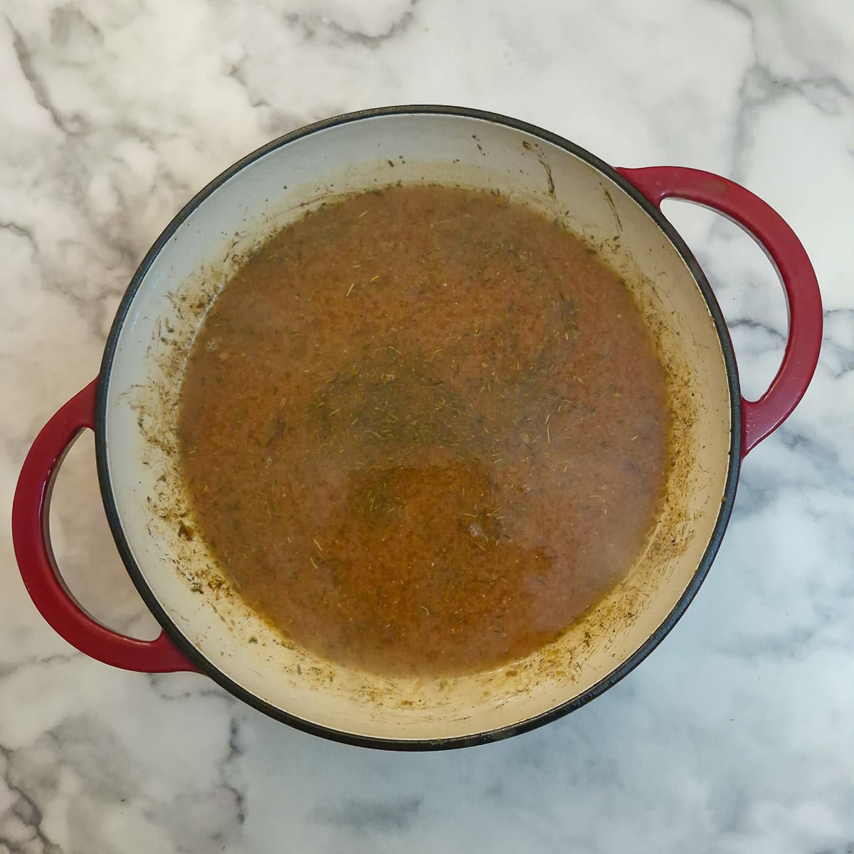 Stock added to the casserole dish.