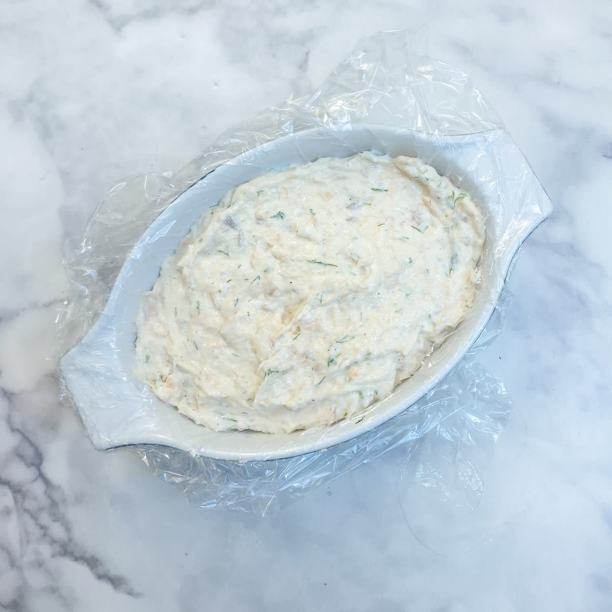 Salmon terrine fully assembled in a white dish.