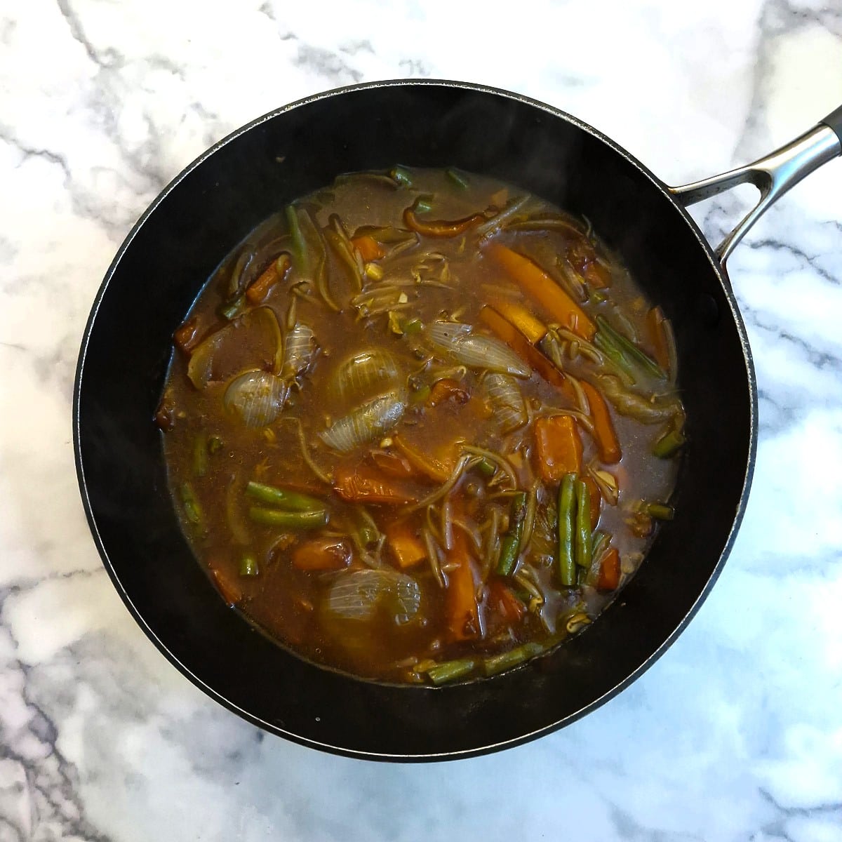 The cooked garlic vegetable sauce in a frying pan.