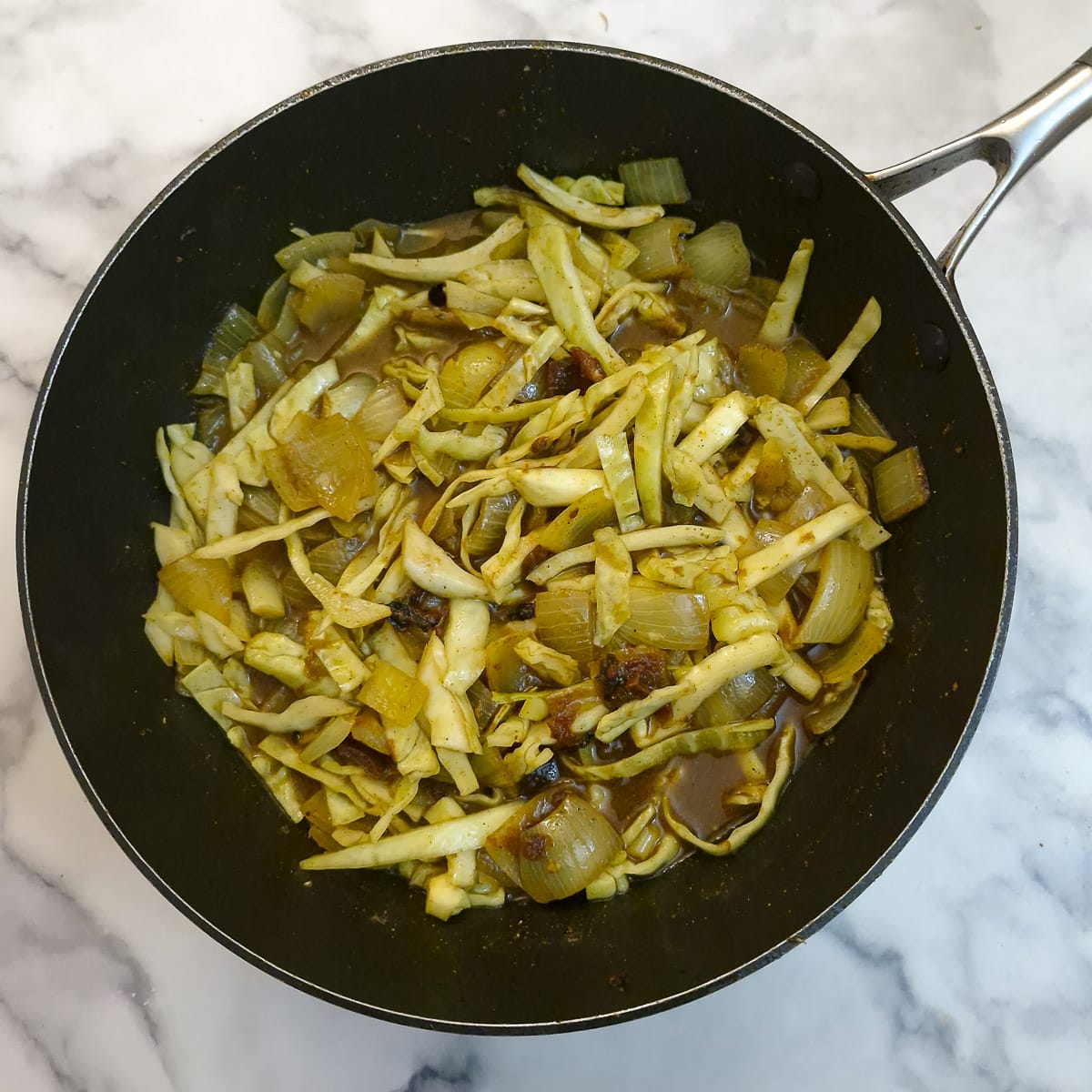 Step 5. Shredded cabbage and grated potato added to the onions.