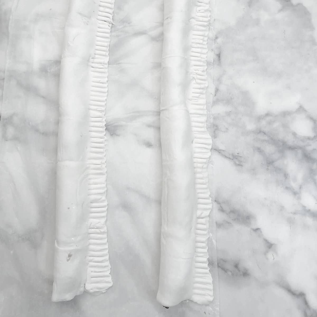 2 rolls of puff pastry folded over the sausage filling and sealed with a fork.