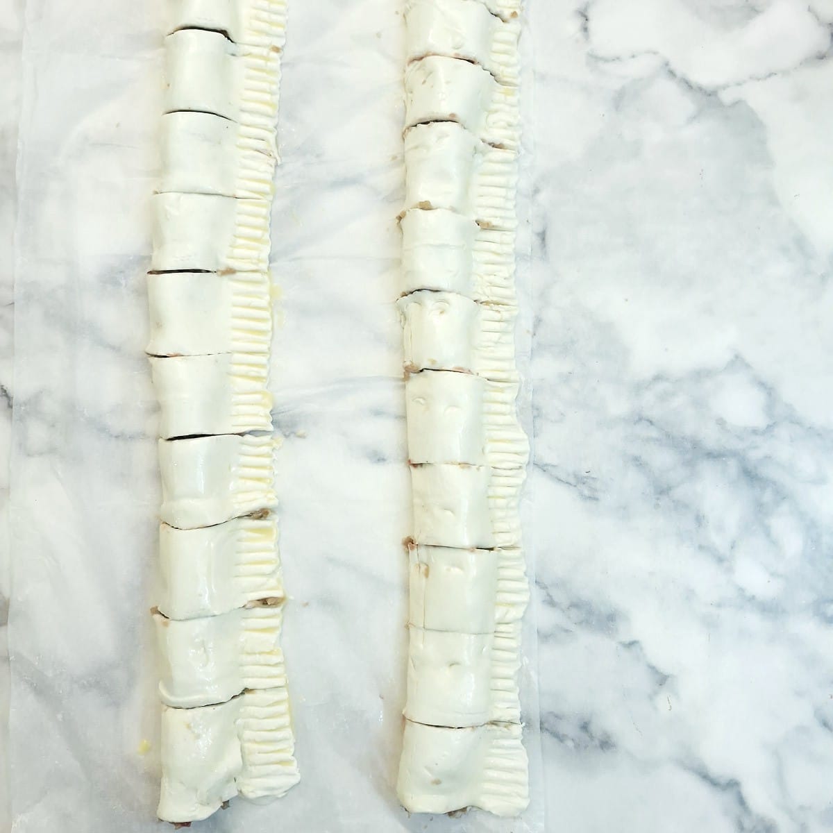 2 rolls of puff pastry sausage rolls, brushed with beaten egg and cut into short lengths.