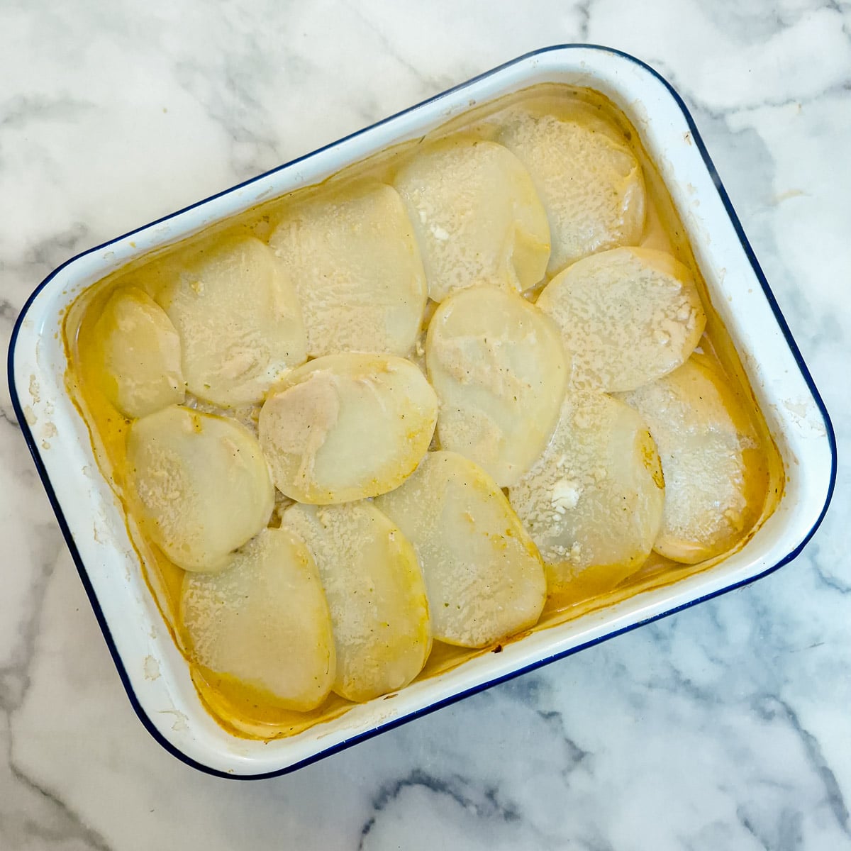 Step 7 - the partially baked dish of potatoes diane after it has been in the oven for an hour.