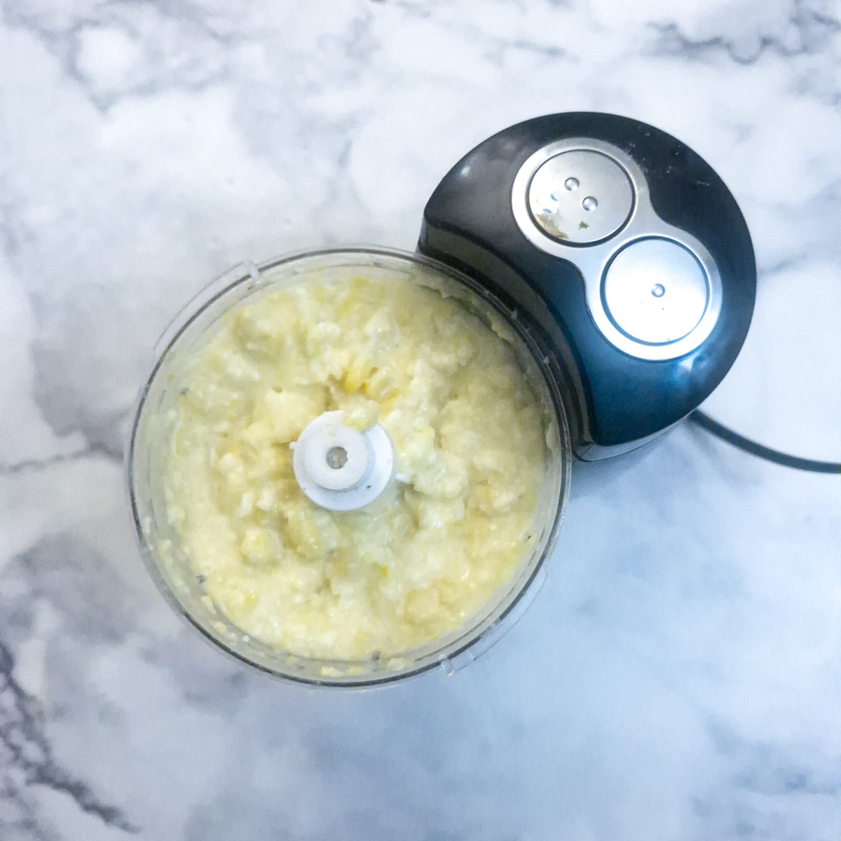 Corn, cheese and eggs in a food processor.