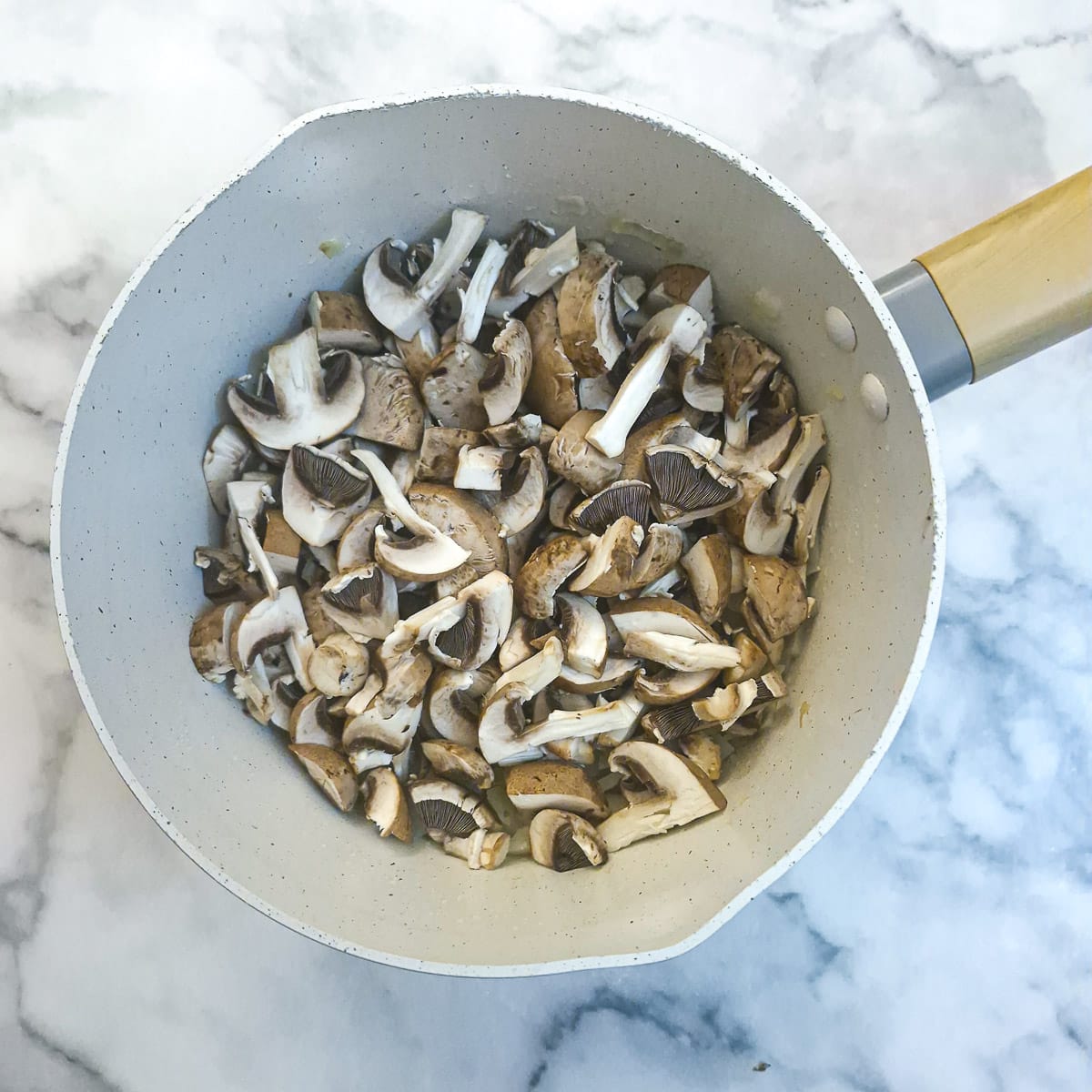 Sliced mushrooms added to the onions.