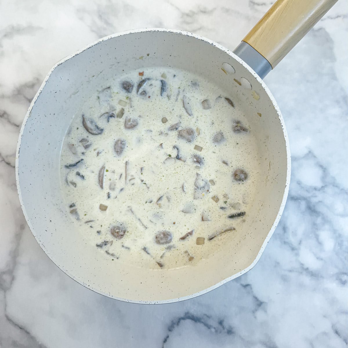 Cream, stock and mustard added to the onions and mushrooms and reduced over low heat to form a sauce.