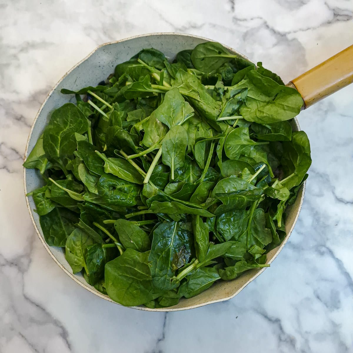 Baby spinach leaves added to the mushrooms and onions.