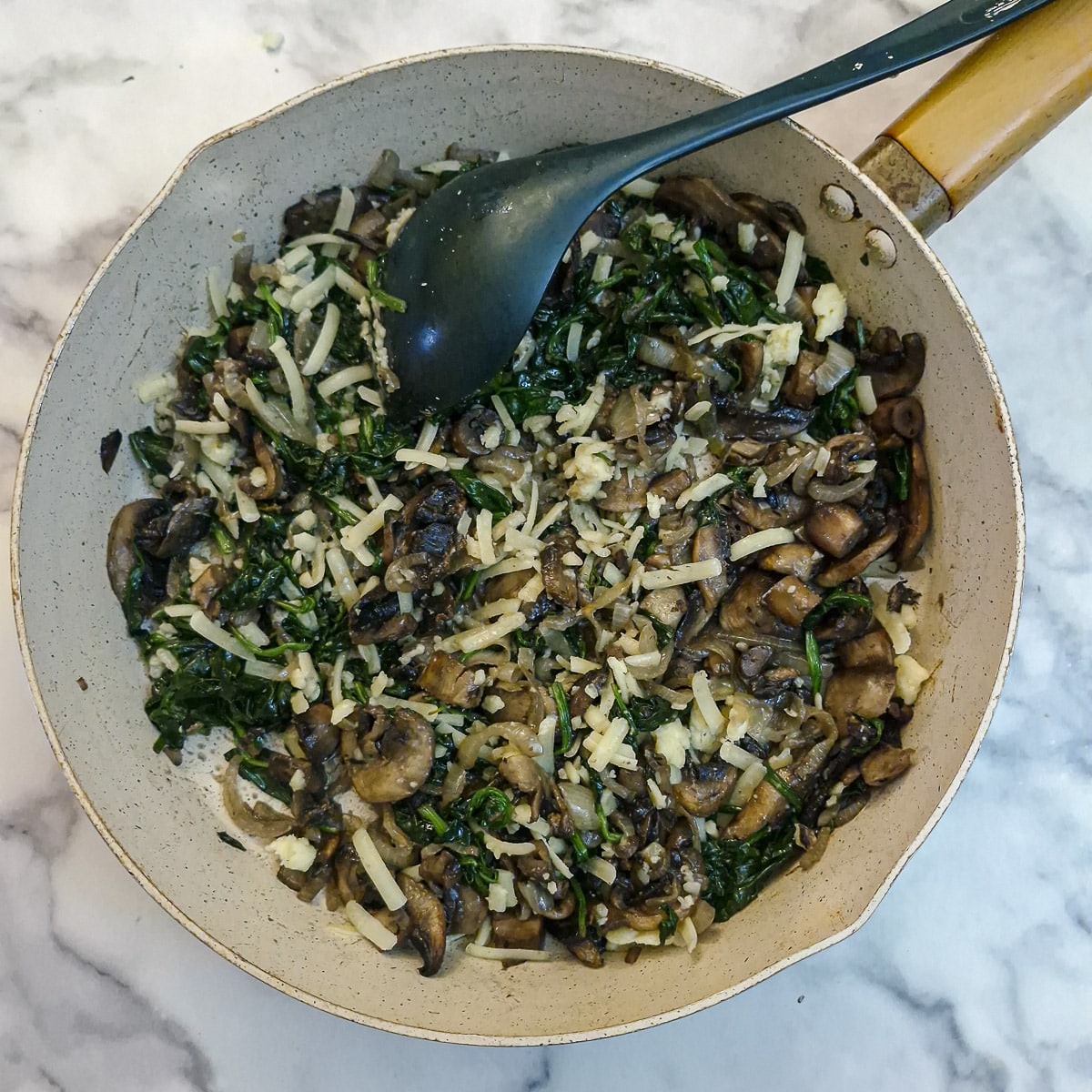 Grated cheese added to the cooled filling.