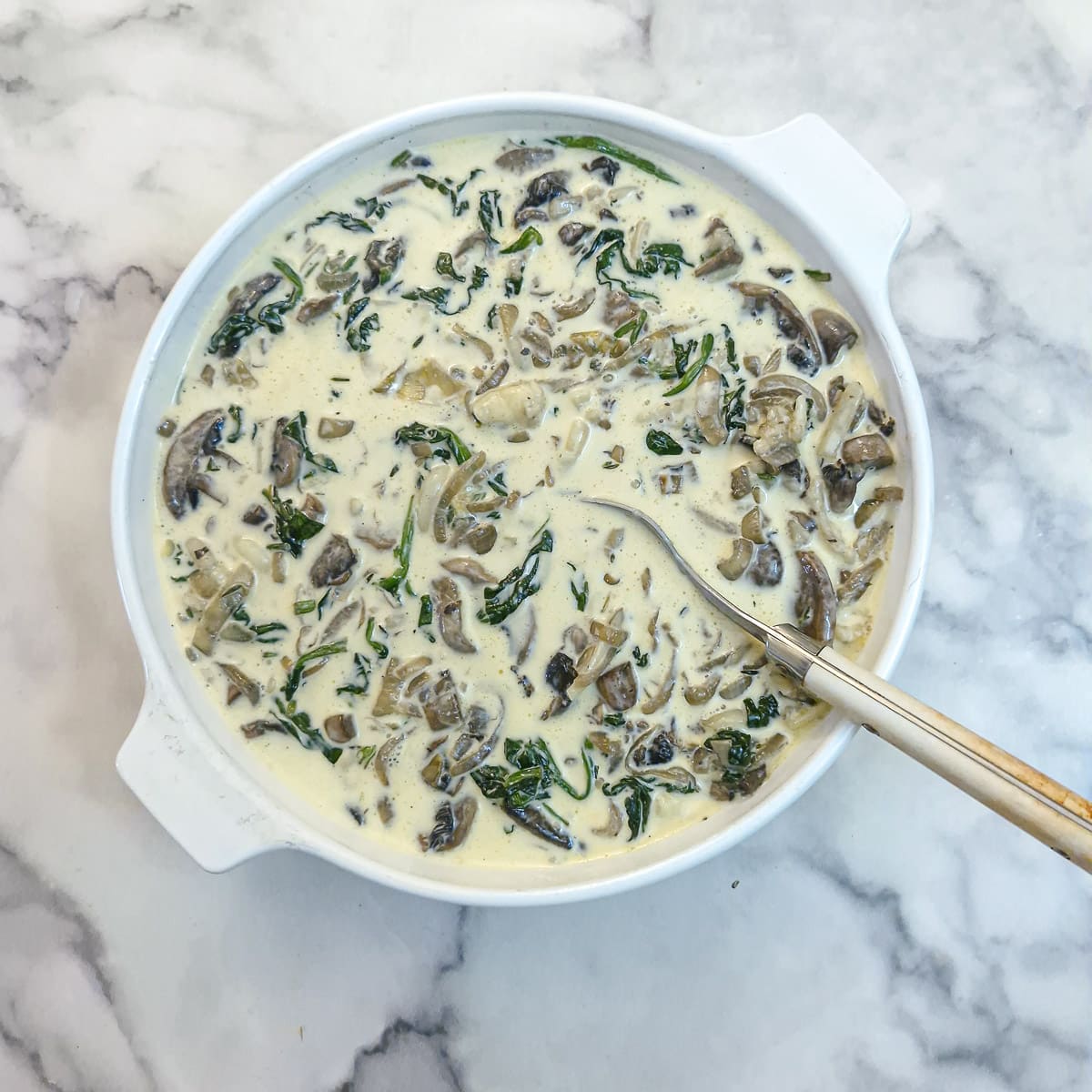 The egg mixture poured over the quiche filling.