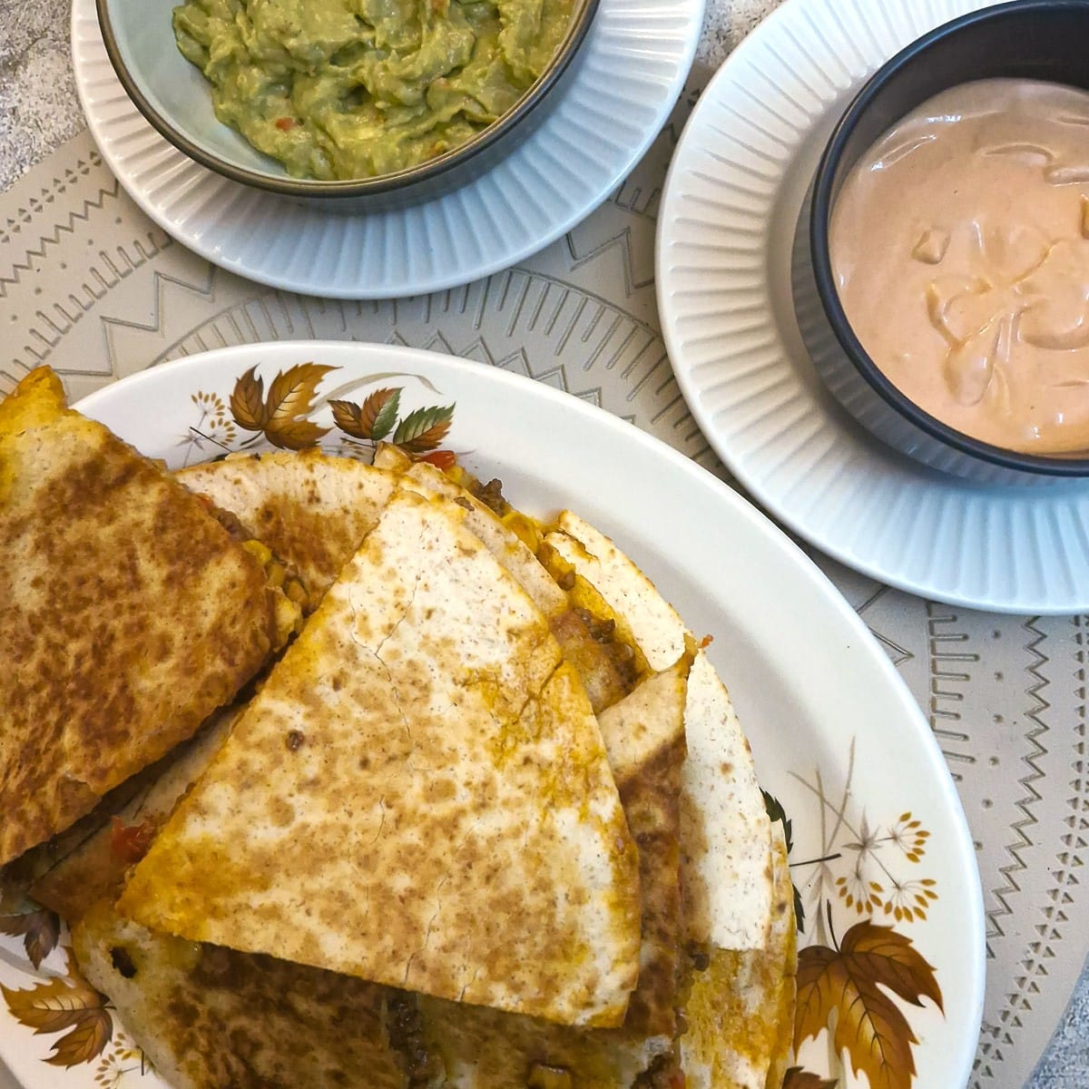 Close up of slices of quesadilla on a plate.