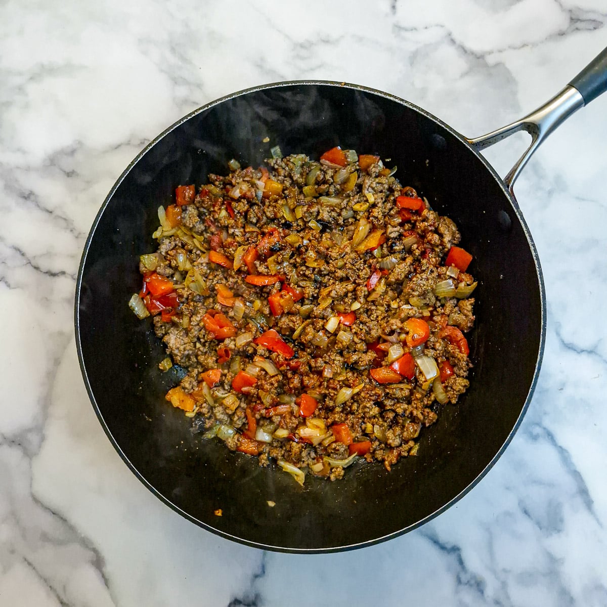 Peppers and onions combined wit the browned ground beef.