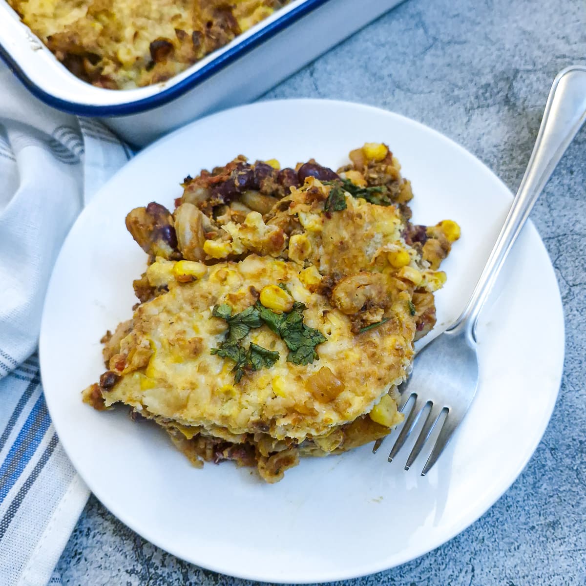 A serving of chilli con carne pasta bake on a white plate.