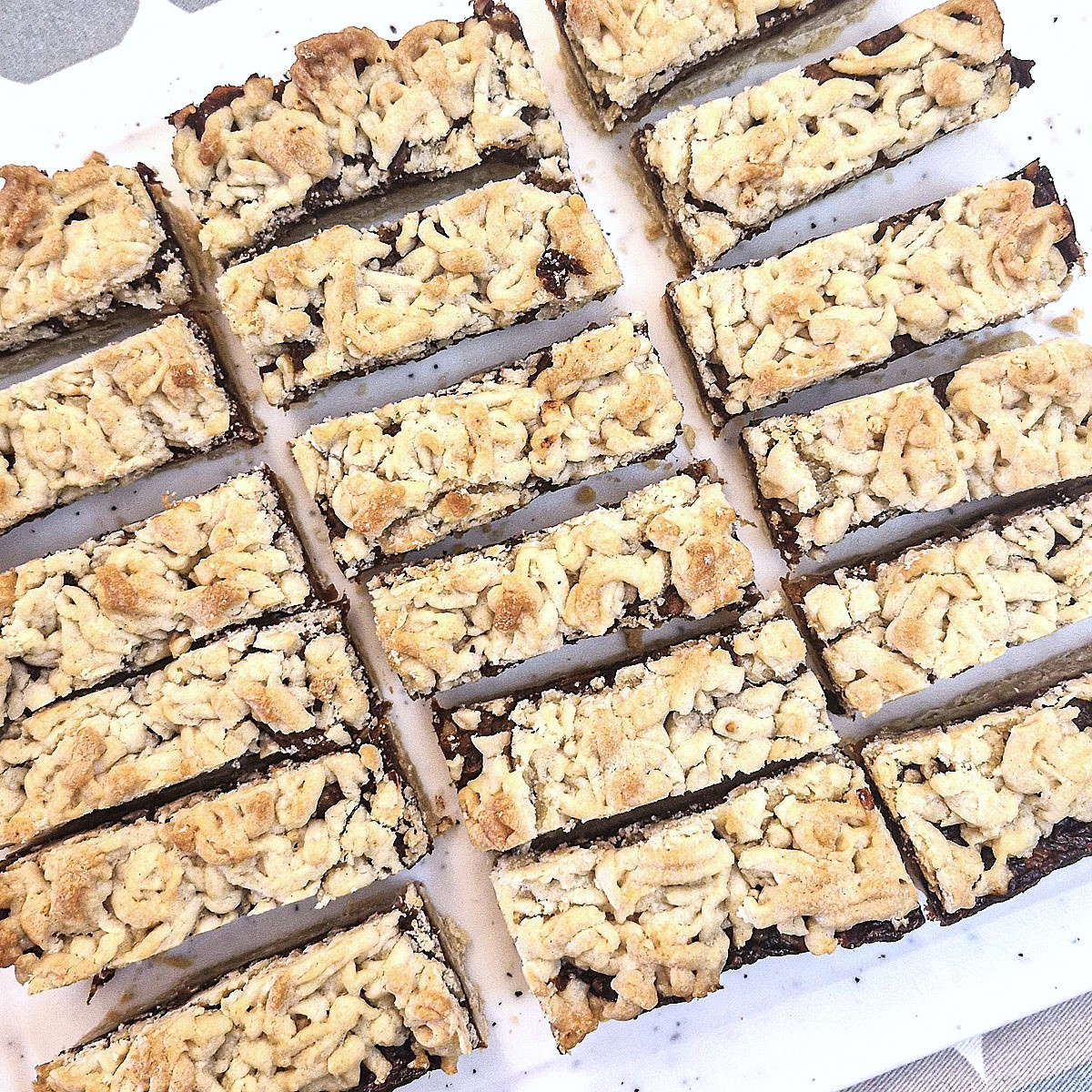 Date and welnut crumble that has been cut into slices.