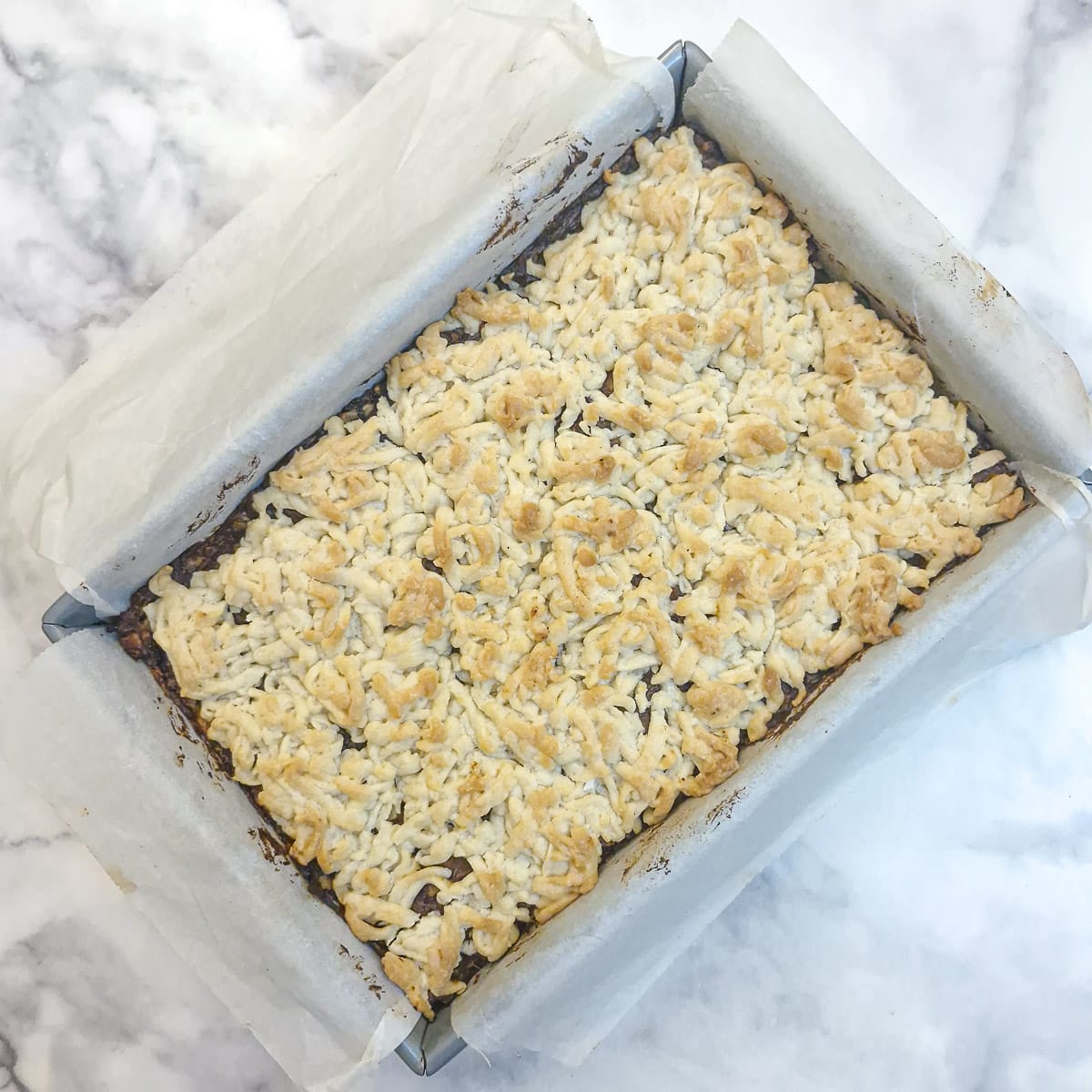 A nicely browned tray of baked date and walnut crumble.