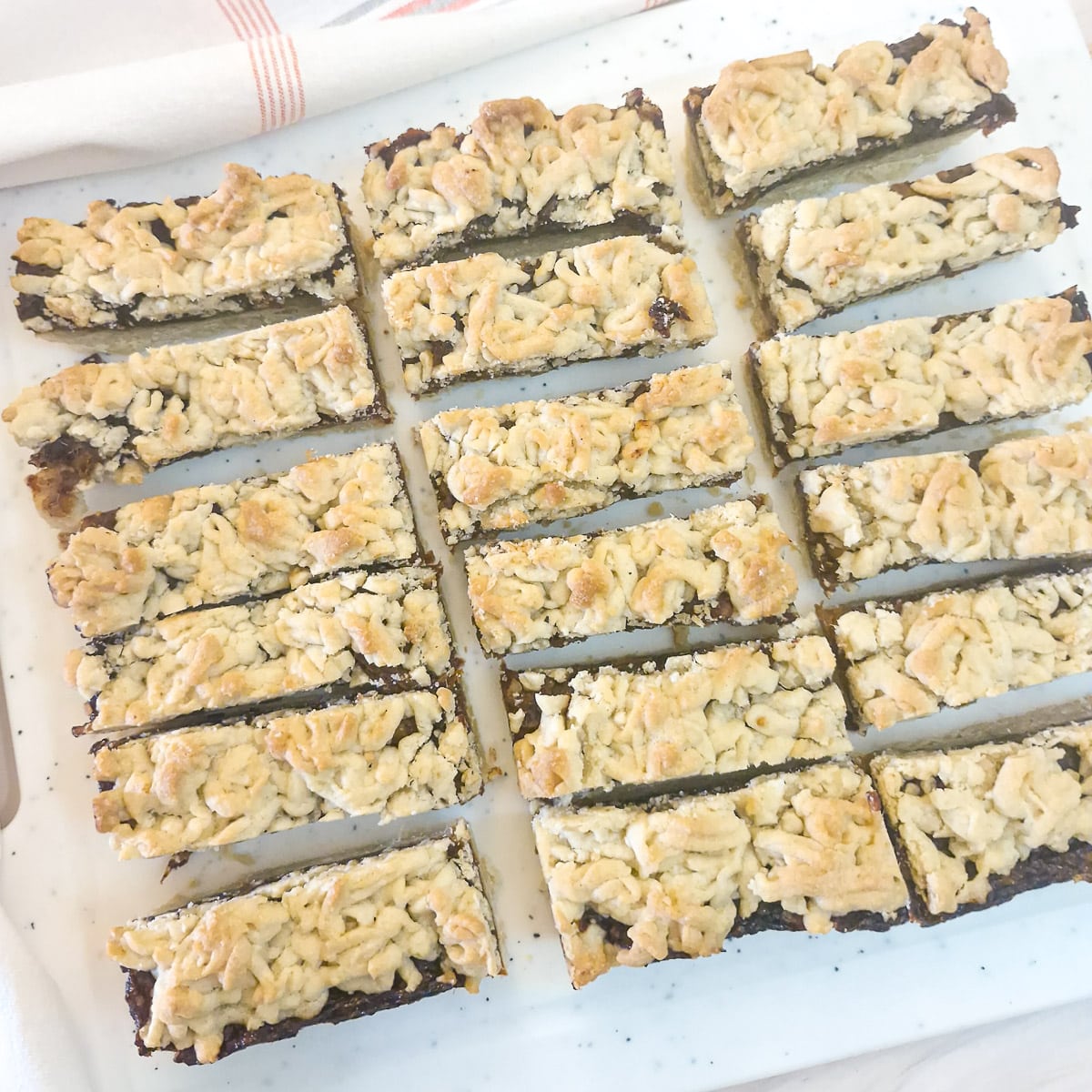 Date and welnut crumble that has been cut into slices.