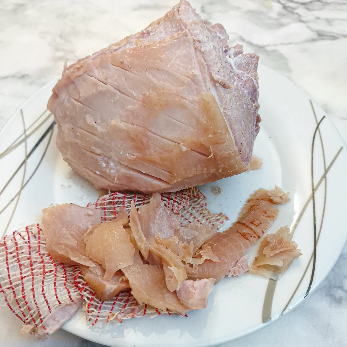 The net and outer layer of skin removed from the boiled gammon.