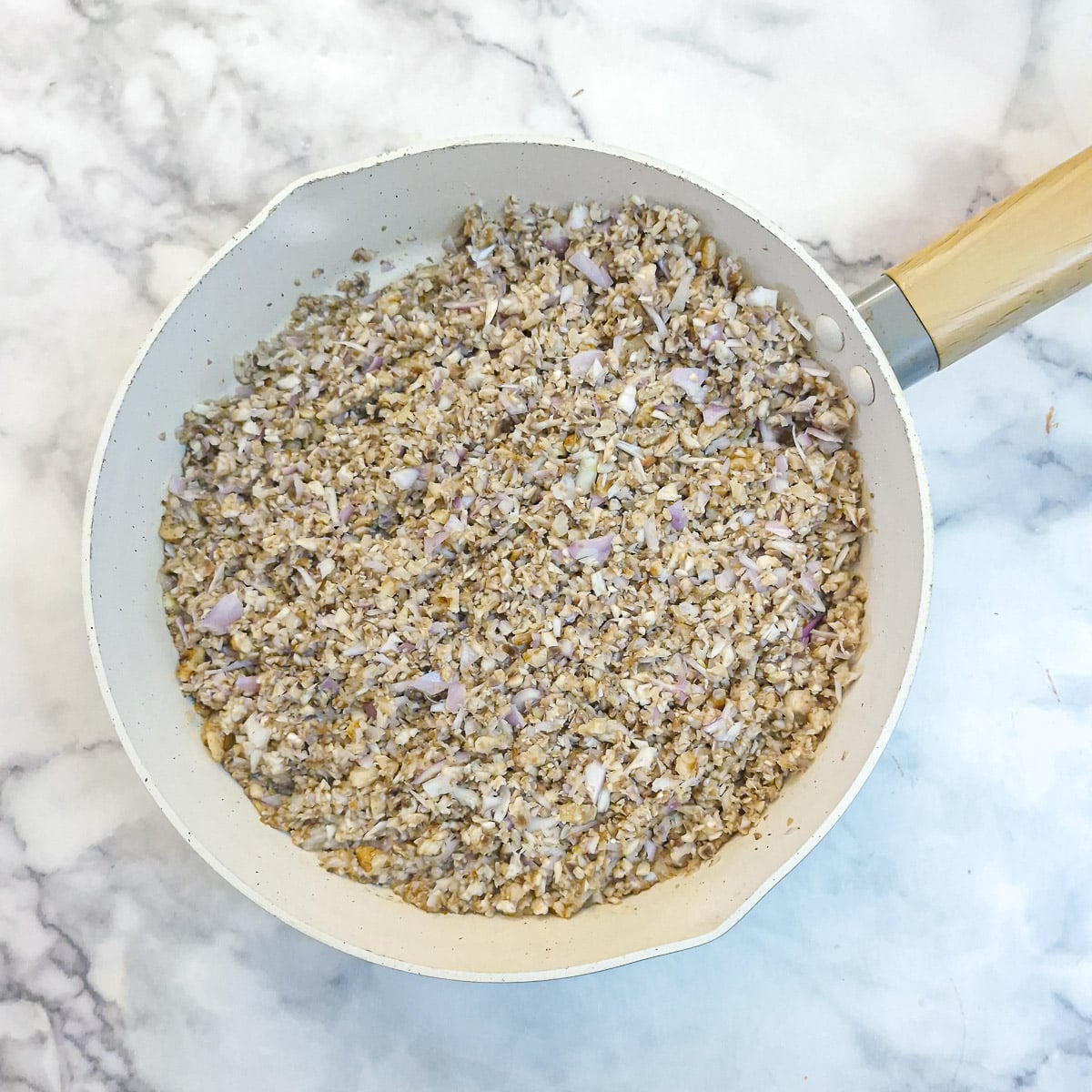 The chopped mushroom mixture in a frying pan.