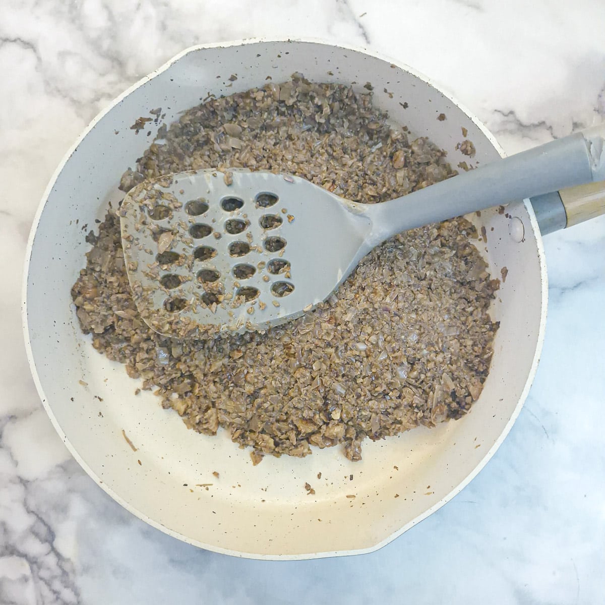 The mushroom mixture after having cooked for a further 5 to 10 minutes. The moisture has all evaporated.