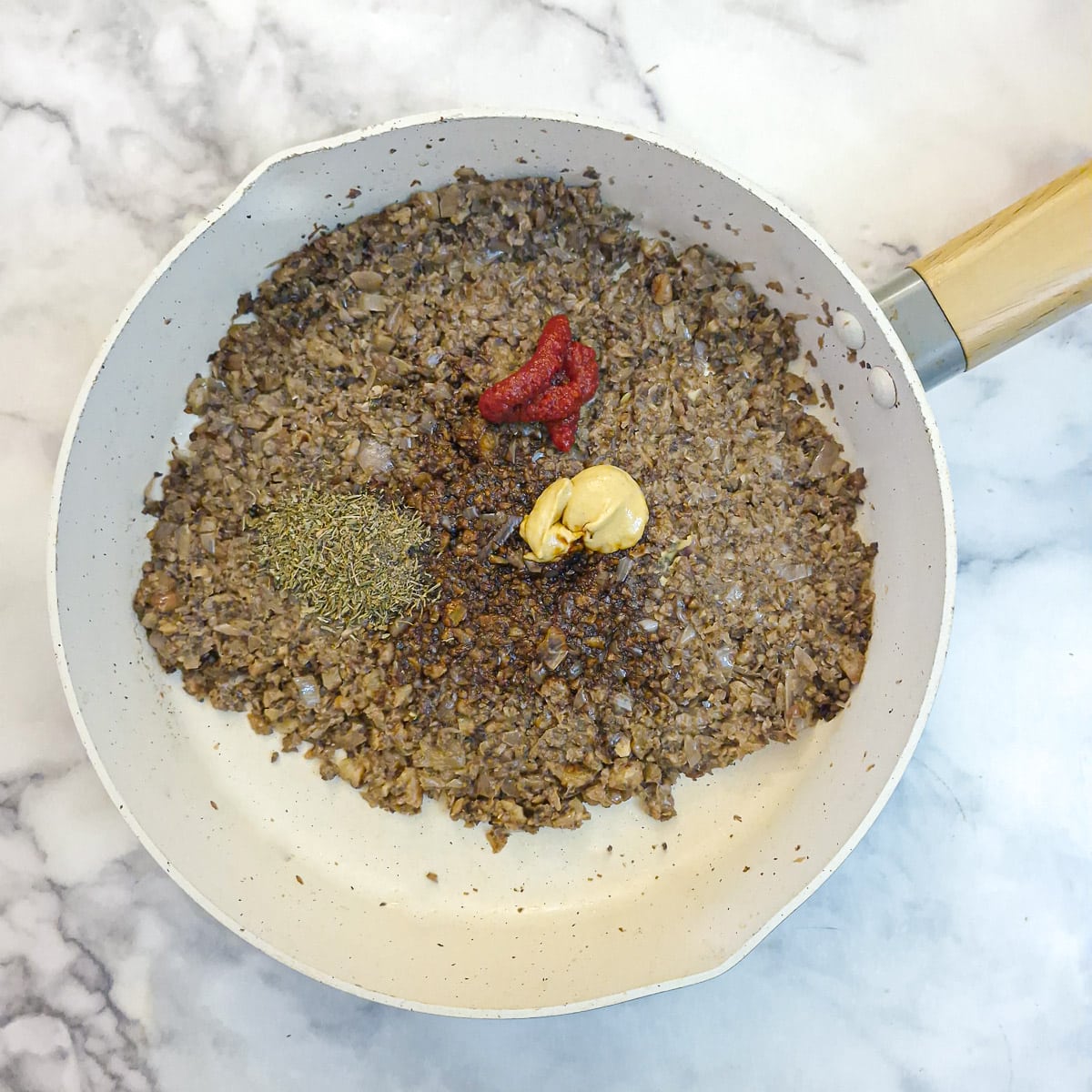 Thyme, black pepper, soy sauce, Dijon mustard and tomato puree added to the mushrooms.