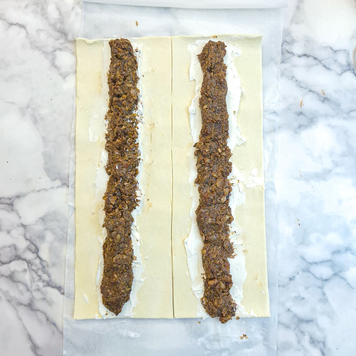 Mushroom filling arranged over cream cheese on puff pastry.