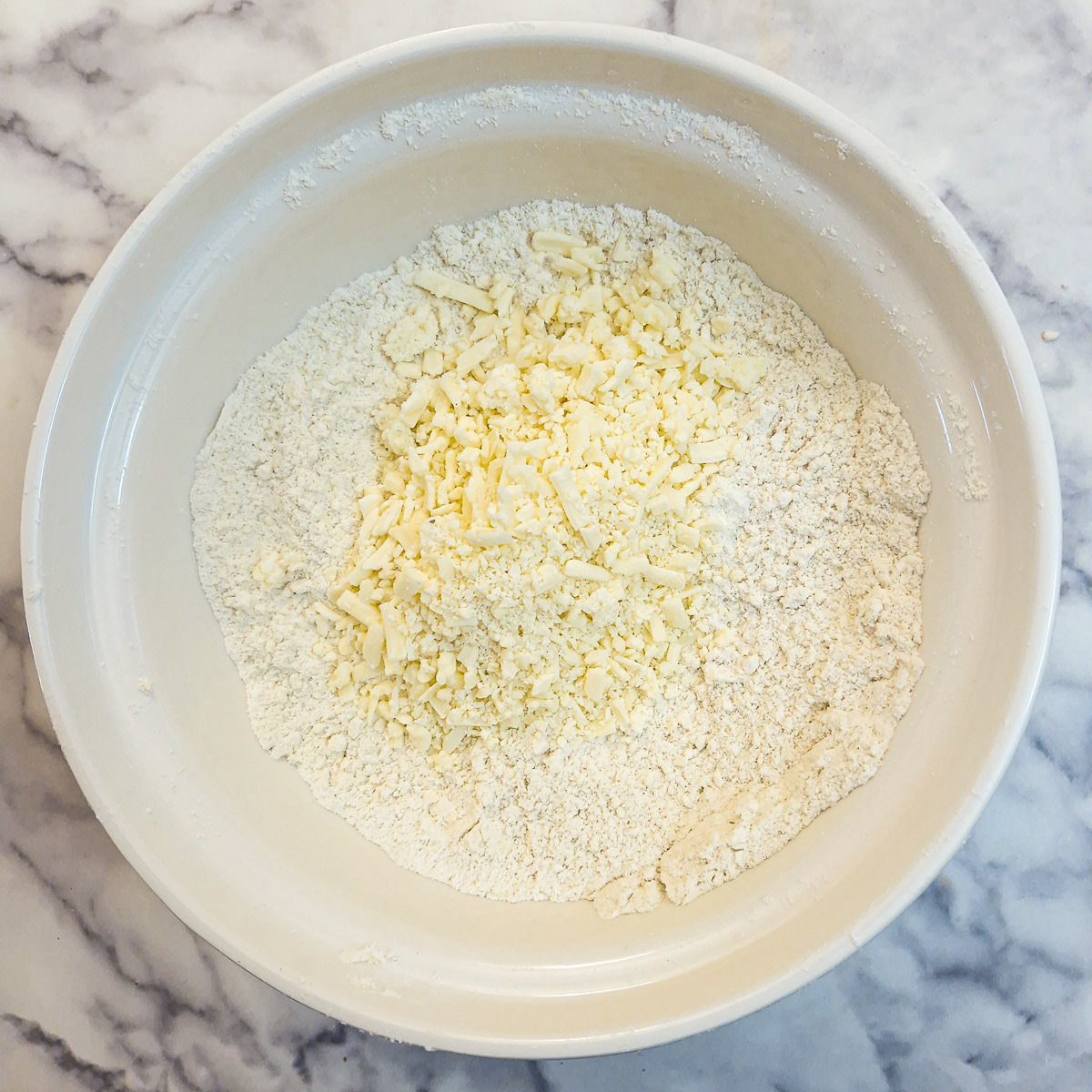 Graated cheese added to the flour and margarine.