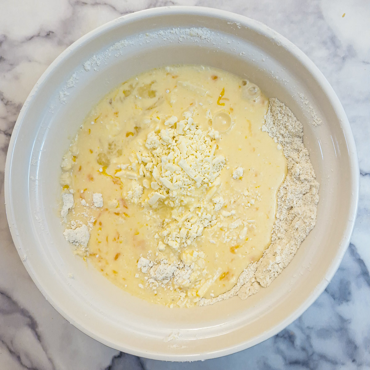 Egg and milk mixture poured on to the flour and margarine 'breadcrumbs'.