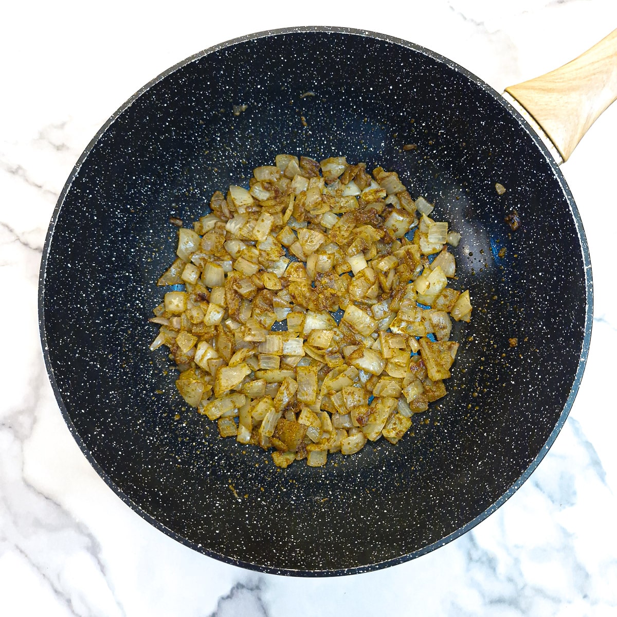 Curry powder and cardamom fried with the onions.