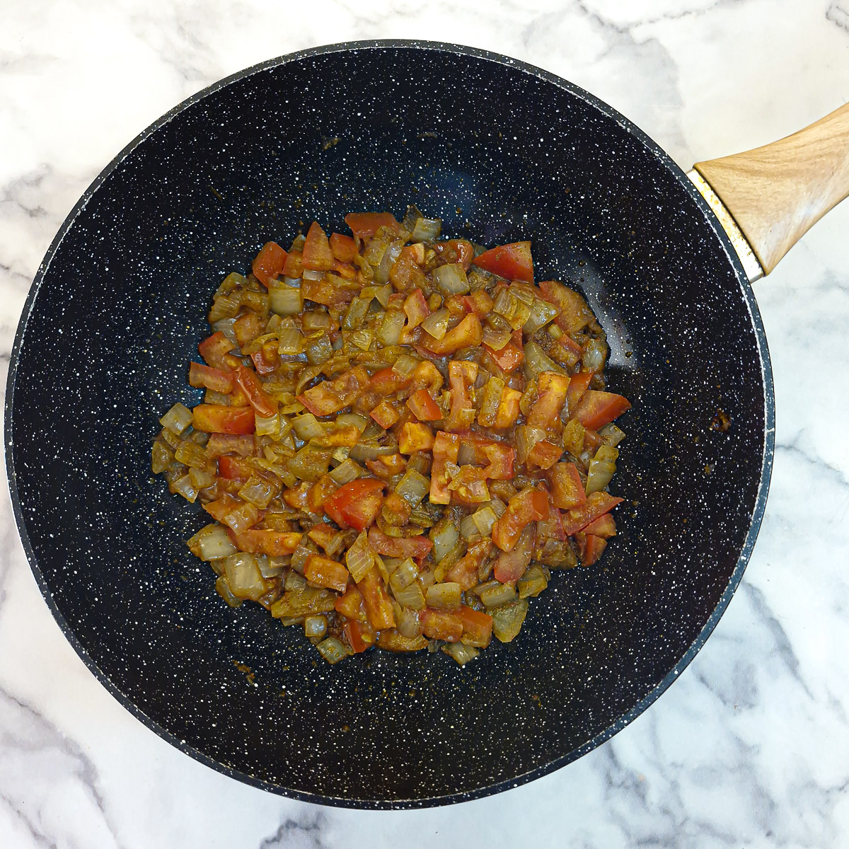 Tomatoes softened with the onions.